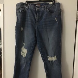 Fashionable  ripped blue jeans with ragged bottoms